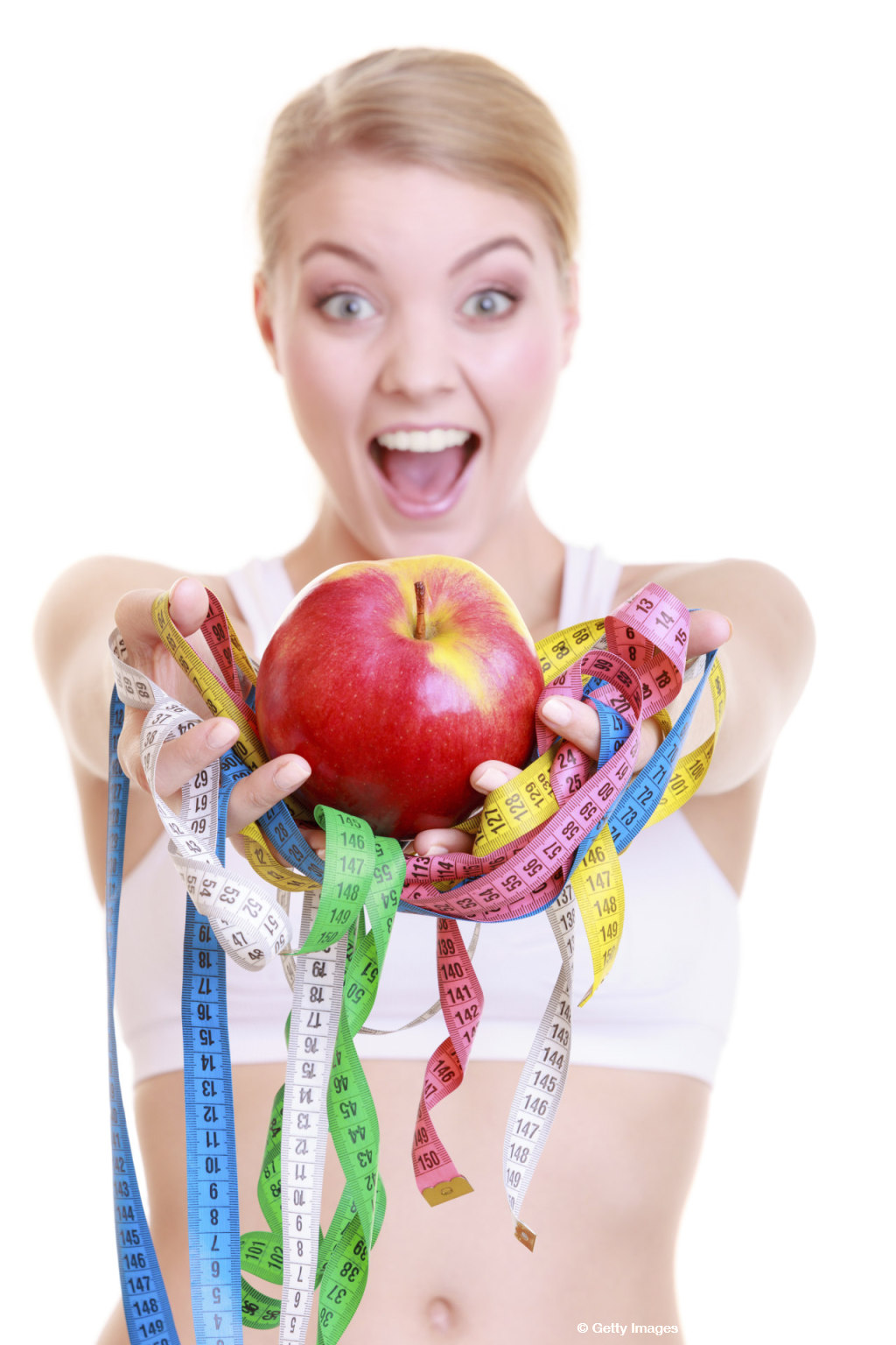 Fitness woman fit girl holding colorful measure tapes fruit
