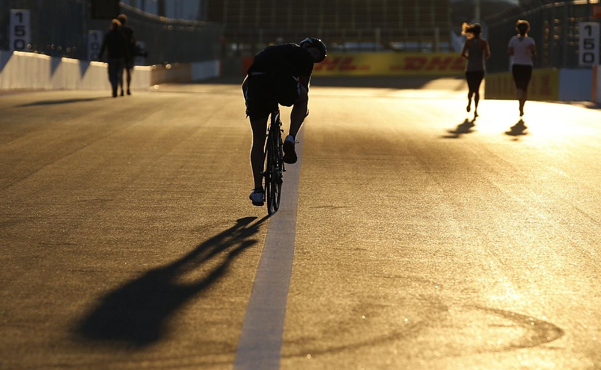 Formula One personnel run and cycle along the Sochi Autodrom фото (photo)