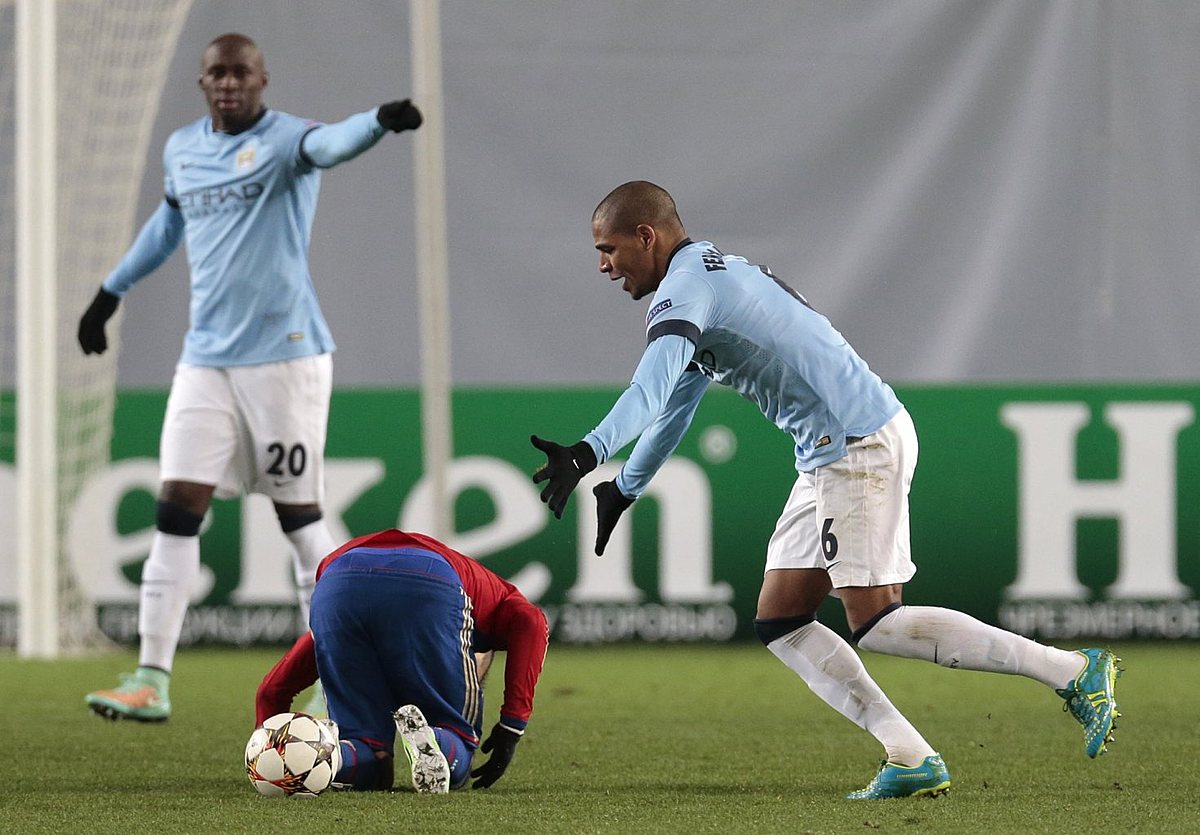 Manchester City's Fernando, right, reacts after fouling фото (photo)