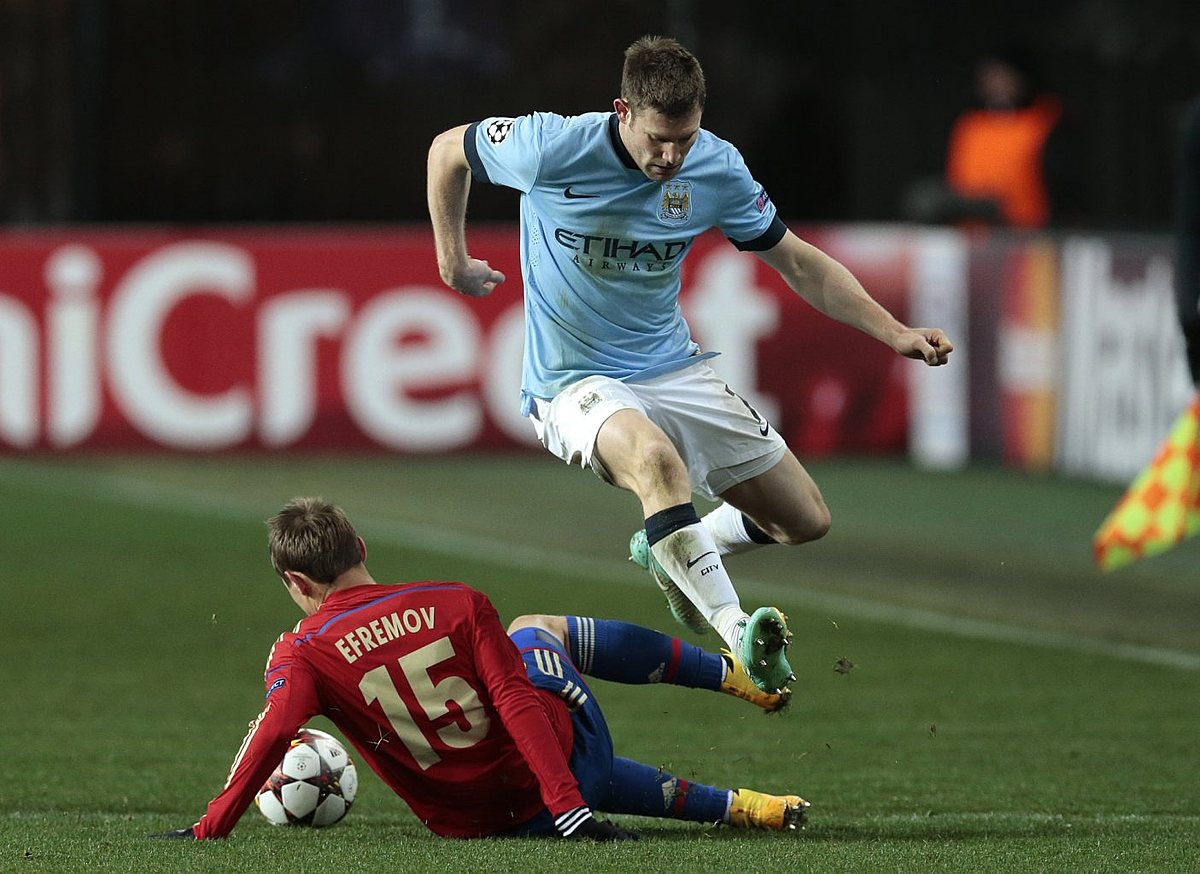Manchester City's James Milner leaps over a challenge from фото (photo)