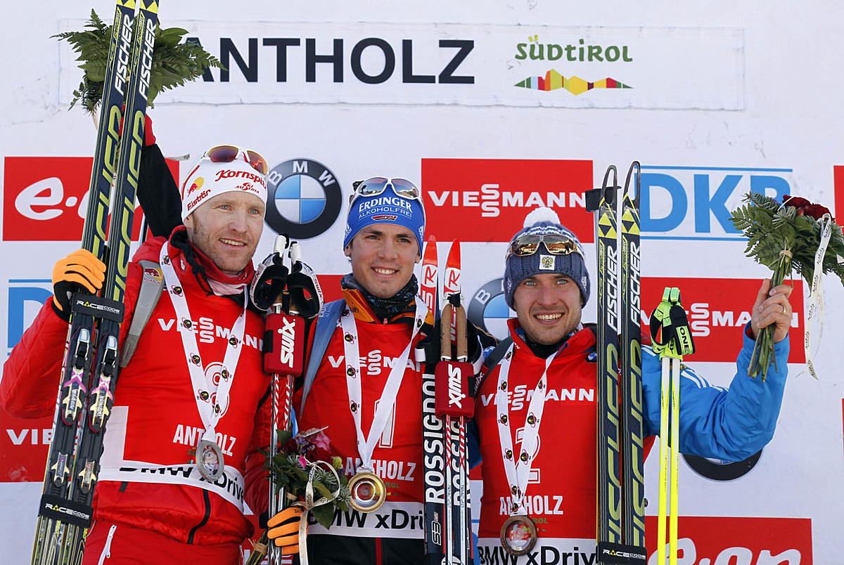Winner Simon Schempp, center, of Germany, celebrates on the podium фото (photo)