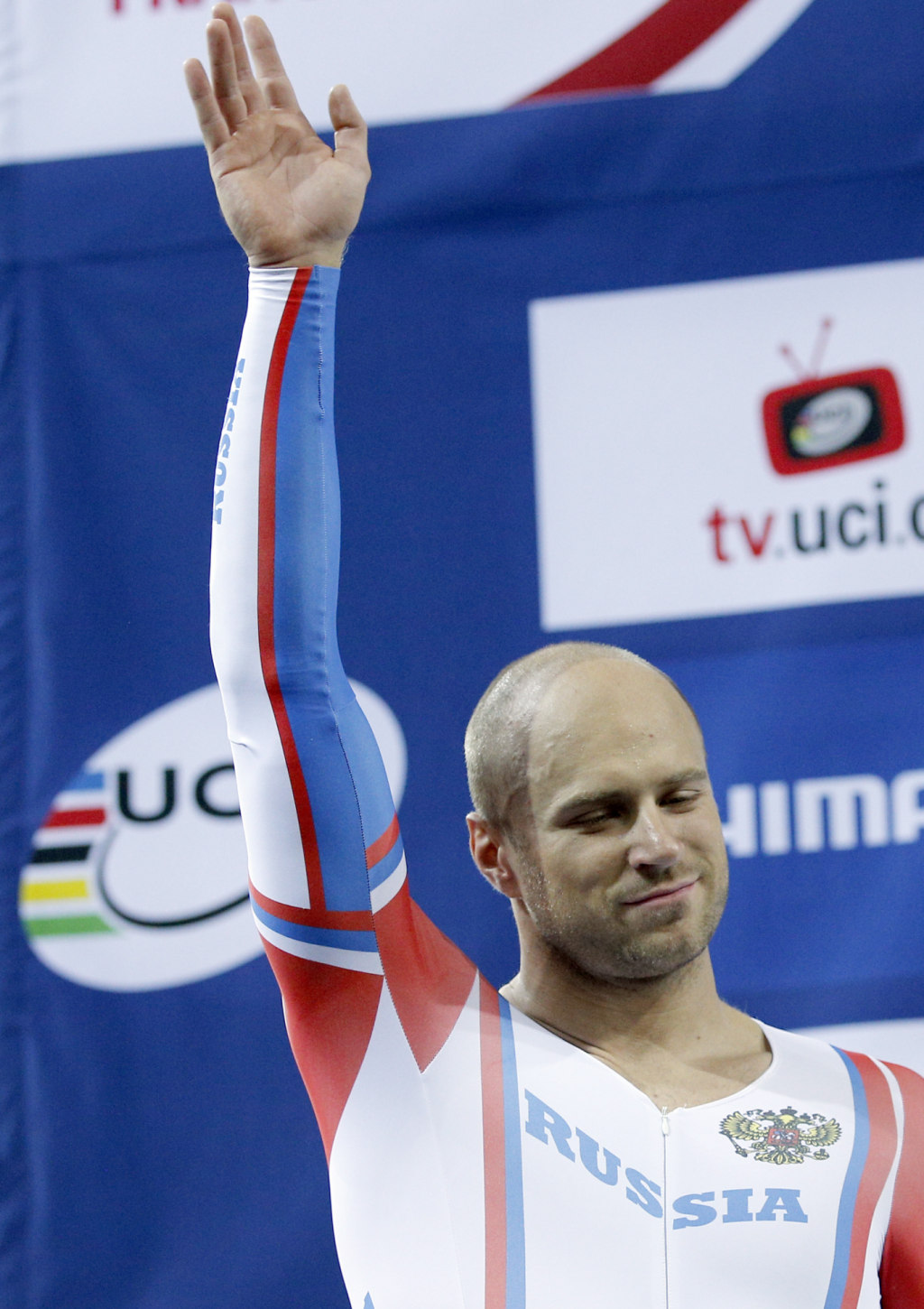 Silver medalist Denis Dmitriev of Russia, celebrates on the podium фото (photo)