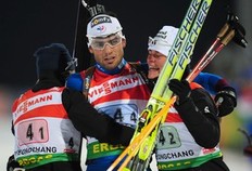 Simon Fourcade (C) celebrates with his French team members Sylvie Becaert (R) and Marie Laure Brunet (L) after winning the mixed relay at the IBU World Biathlon Championships in Pyeongchang, east of Seoul on February 19, 2009. France won the mixed relay title at the world biathlon championships here ahead of Sweden and Germany.