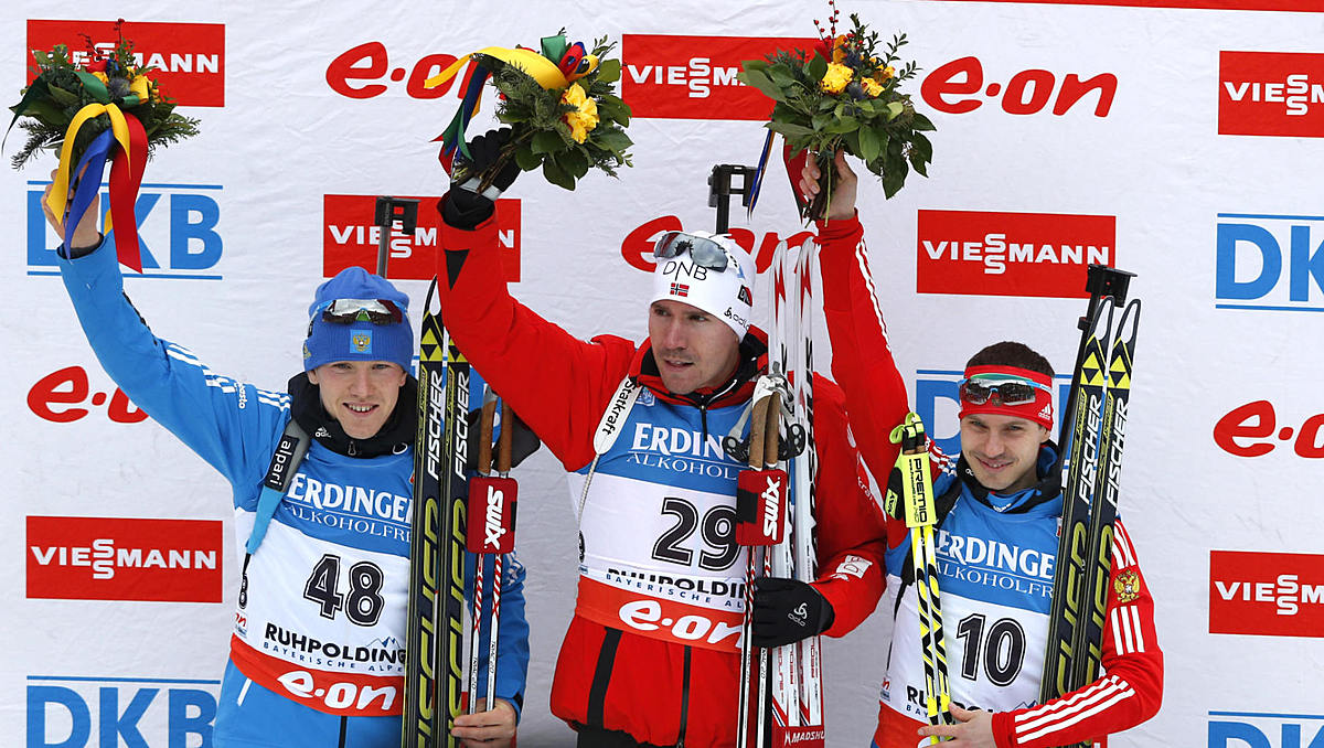 Norway's Emil Hegle Svendsen, center, celebrates on the podium фото (photo)