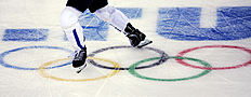 Конькобежный спорт A player skates across the Olympic rings during a first round фото (photo)
