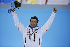MenвЂ™s biathlon 10k sprint gold medalist Norway's Ole Einar Bjoerndalen celebrates on the podium during the medals ceremony at the 2014 Winter Olympics,...