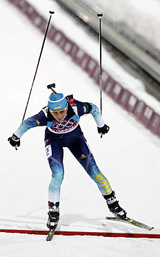 Ukraine's Vita Semerenko crosses the finish line to win the bronze medal the women's biathlon 7.5k sprint, at the 2014 Winter Olympics, Sunday, Feb. 9,...