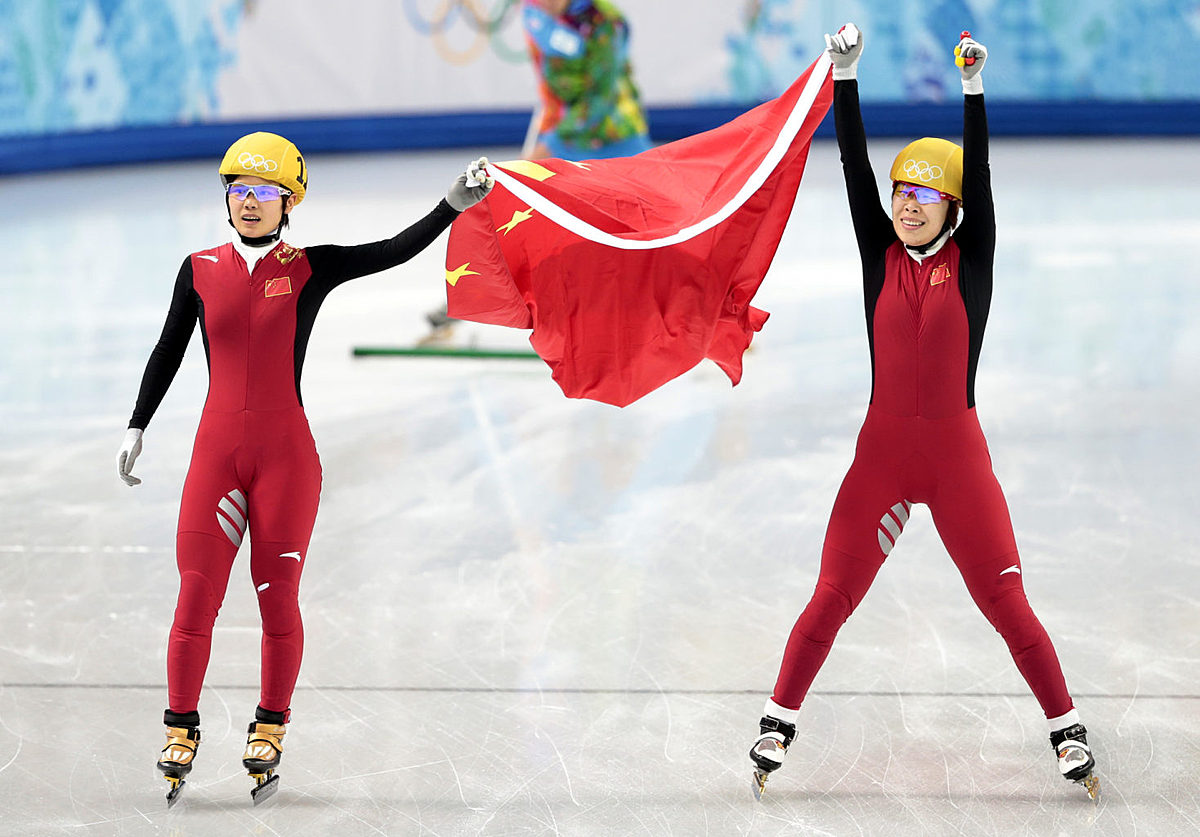 Zhou Yang of China, right, celebrates placing first in a women фото (photo)