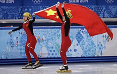 Конькобежный спорт Zhou Yang of China, right, celebrates placing first in a women фото (photo)