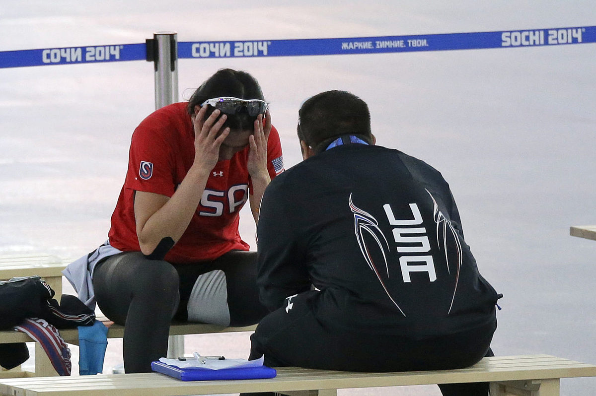 Brittany Bowe of the U.S. holds her head and sits with coach фото (photo)