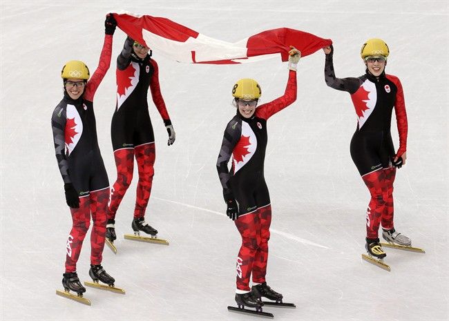 The Canadian team celebrate their second place in the women& фото (photo)