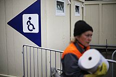 Конькобежный спорт A worker carries a roll of paper towels out of a restroom for фото (photo)