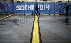 Конькобежный спорт A man steps over one of several cable protectors next to the фото (photo)