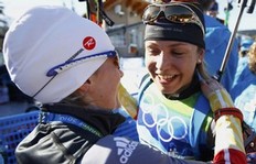 Germany's Magdalena Neuner is congratulated after winning the women's 12.5 km mass start biathlon final at the Vancouver 2010 Winter Olympics in Whistler, British Columbia, February 21, 2010. Neuner won the gold medal ahead of Russia's Olga Zaitseva who won silver and compatriot Simone Hauswald who won bronze.
