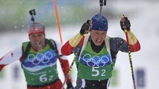 Germany's Andreas Birnbacher skis ahead of Switzerland's Matthias Simmen (L) during the men's 4 x 7.5 km relay biathlon final at the Vancouver 2010 Winter Olympics in Whistler, British Columbia, February 26, 2010.