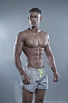 Фитнес Fitness black african man. Swimwear fashion. Studio shot against grey.