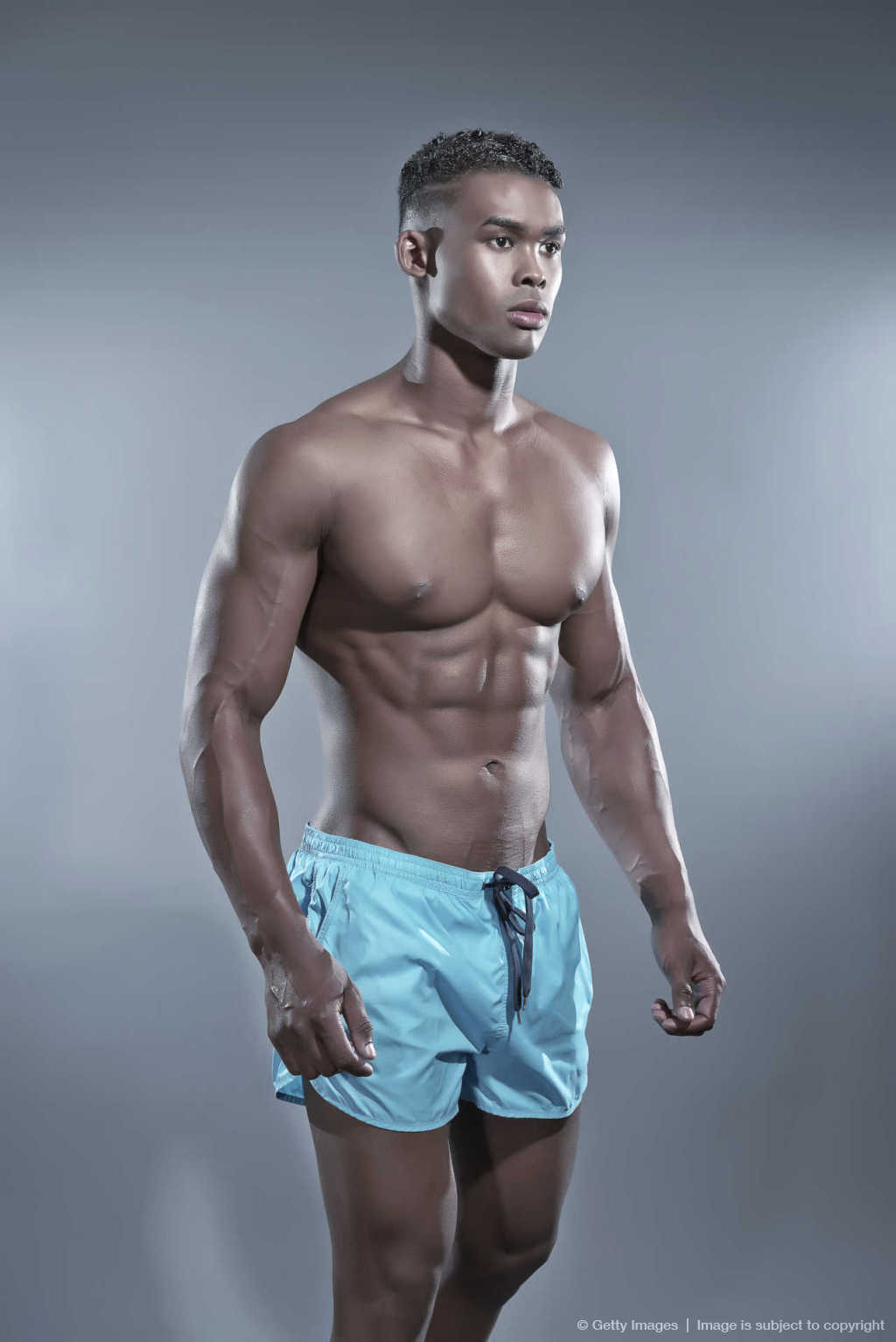 Fitness black african man wearing blue shorts. Swimwear fashion.
