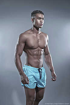 Фитнес Fitness black african man wearing blue shorts. Swimwear fashion.