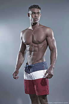 Фитнес Fitness black african man wearing striped shorts. Swimwear fashion.