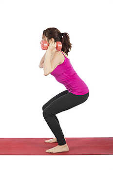 Фитнес Fitness woman in squat pose with dumbbells