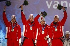 Austria's silver medallists Christoph Sumann, Dominik Landertinger, Daniel Mesotitsch and Simon Eder wave during the medal ceremony for the men's biathlon 4x7.5km relay at the Vancouver 2010 Winter Olympics, in Whistler, British Columbia, February 26, 2010.