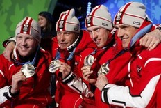 Silver medallists Austria's Simon Eder, Daniel Mesotitsch, Dominik Landertinger and Christoph Sumann (L-R) pose during the medals ceremony for the men's 4 X 7.5 kilometres relay biathlon event at the Vancouver 2010 Winter Olympics at Whistler, British Columbia February 26, 2010.