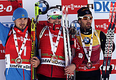 Winner Norway's Emil Hegle Svendsen, center, celebrates his victory with runner up Russia's Anton Shipulin, left and third placed France's Martin Fourcade,...
