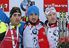 Russia's Anton Shipulin, center, celebrates his victory with runner up France's Martin Fourcade, left and third placed Austrian Simon Eder after the men's...