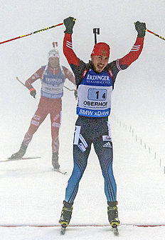 Anton Shipulin of Russia, right, celebrates as he crosses the finish line in front of Ole Einar Bjoerndalen of Norway, left, during foggy weather at the...