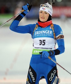 France's Marie-Laure Brunet celebrates as she crosses the finish line in second place during the women's 7, 5 km sprint event of the Biathlon World Cup in the Siberian city of Khanty-Mansiysk on March 25, 2010.