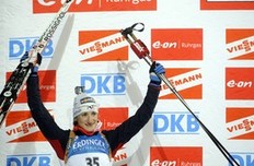 Marie-Laure Brunet from France celebrates her second place on the podium after the women's 7, 5 km sprint event of the Biathlon World Cup in the Siberian city of Khanty-Mansiysk on March 25, 2010.