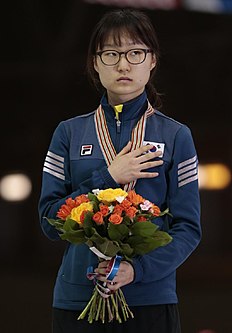 Конькобежный спорт Choi Minjeong, of Korea, listens to the national anthem with фото (photo)