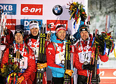 RUHPOLDING, GERMANY — JANUARY 15: Sven Grossegger, Julian Eberhard, Simon Eder and Dominik Landertinger of Austria celebrate third place on the podium after the Men's 4x7.5km relay of the Ruhpolding IBU Biathlon World Cup on January 15, 2016 in Ruhpolding, Germany.