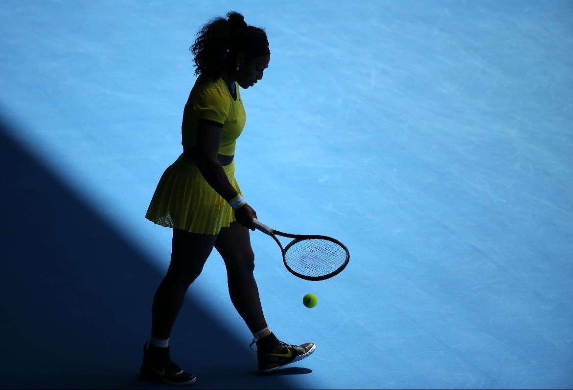 Serena Williams of the United States is silhouetted as she plays фото (photo)