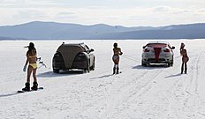 Bikini-clad women ski and snowboard as they are led by cars during a performance on the frozen Yenisei River outside Krasnoyarsk, Siberia, Russia, March 20, 2016. The performance, entitled «Siberian Spring's Strings» and created with the participation of artist Vasily Slonov, marked the day of spring equinox (vernal equinox), according to organizers. REUTERS/Ilya Naymushin