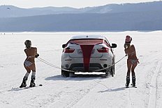 Women in bikini ski during performance outside Krasnoyarsk