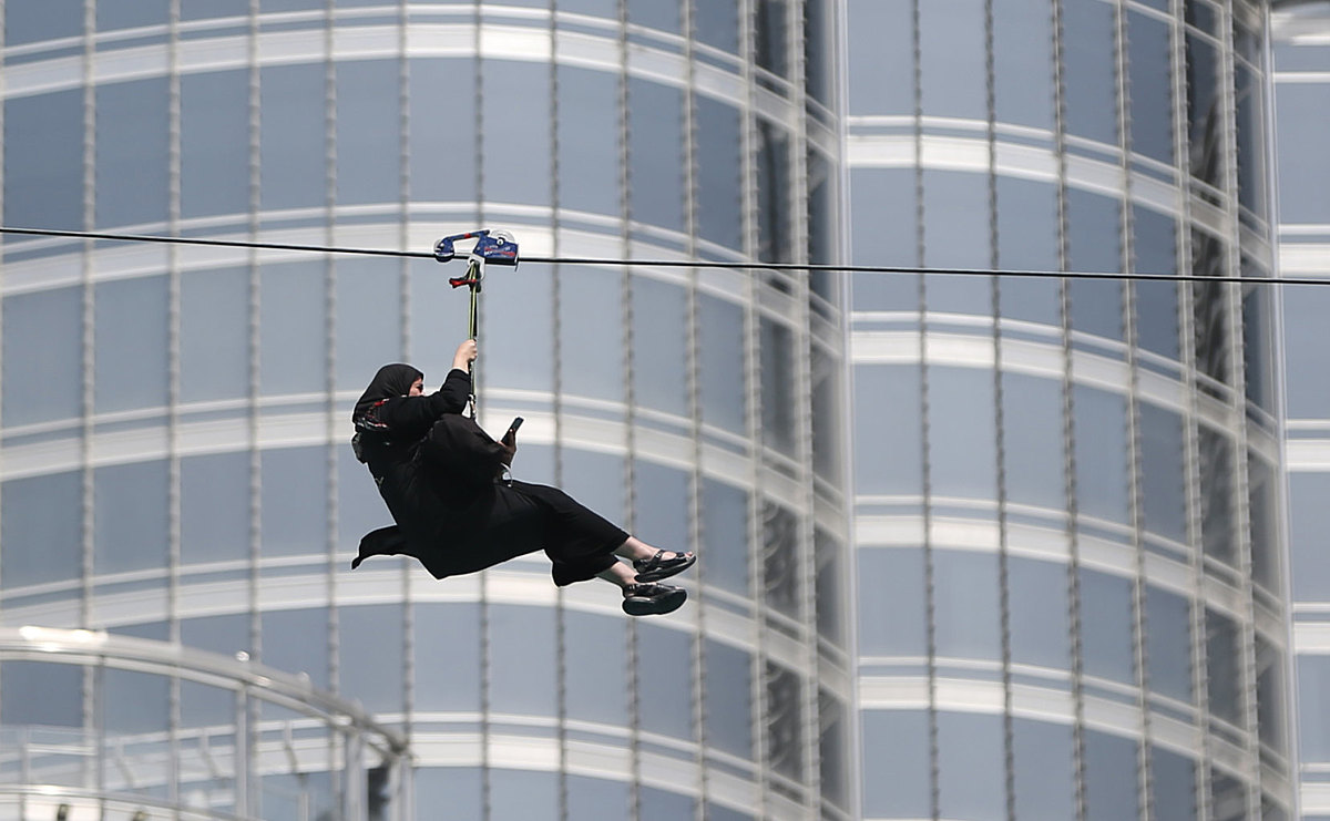In this April 9, 2016 photo, a woman enjoys an urban zip line фото (photo)