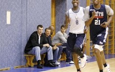 Russian billionaire Mikhail Prokhorov (L on the bench) and Sergey Kushchenko (2nd L on the bench), executive director of the Russian Biathlon Union, watch a training session of New Jersey Nets basketball team in Moscow October 10, 2010. The basketball team, owned by Prokhorov, arrived in Moscow to take part in a masterclass session to demonstrate their skills and talk about their experiences to fans, local media reported.