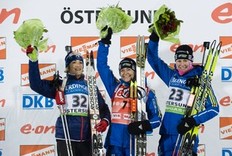 Sweden's Anna Carin Zidek (C) celebrates on the podium with second-placed Marie-Laure Brunet (L) and third-placed Helena Ekholm (R) after winning the women's Biathlon 15km individual race in Oestersund on December 1, 2010.