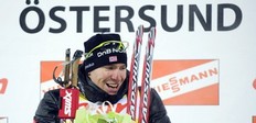 Norway's Emil Hegle Svendsen celebrates on the podium after winning the men's Biathlon 20km individual race on December 2, 2010 in Oestersund, Sweden.