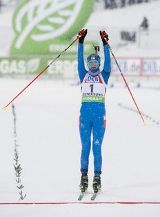 Kaisa Makarainen of Finland celebrate as she crosses the finish line as the winner of the women's Biathlon 10 km pursuit race on December 5, 2010 in Oestersund, Sweden.