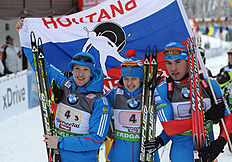 The Russian Team (from L) Alexey Volkov, Olga Vilukhina, Anton Shipulin Hold Their Flag As...