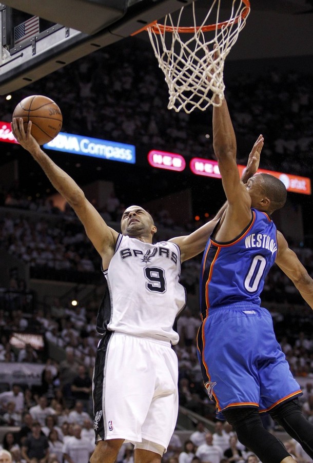 San Antonio Spurs point guard Tony Parker holds off ...