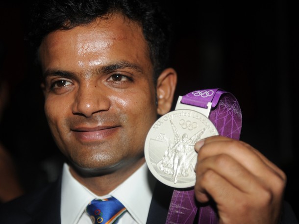 Indian Olympic silver medal winner Vijay Kumar poses during an фото