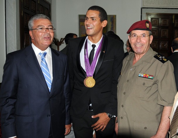 Olympic champion, swimmer Oussama Mellouli (C) poses with Tunisian фото