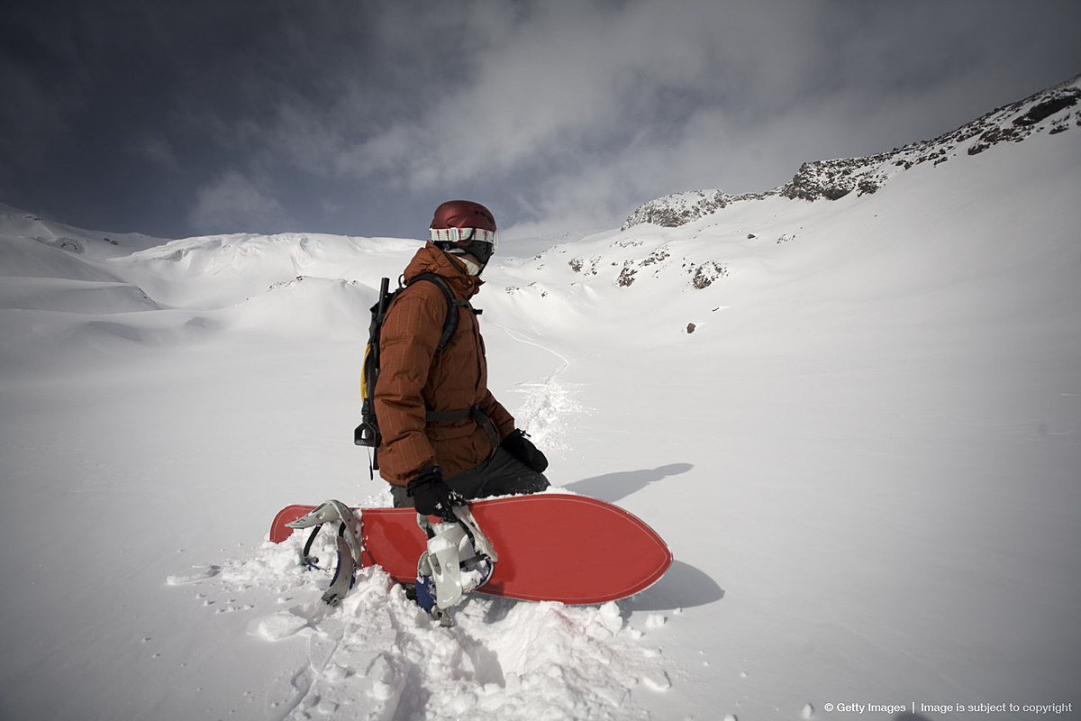 Man holding Snowboard Side